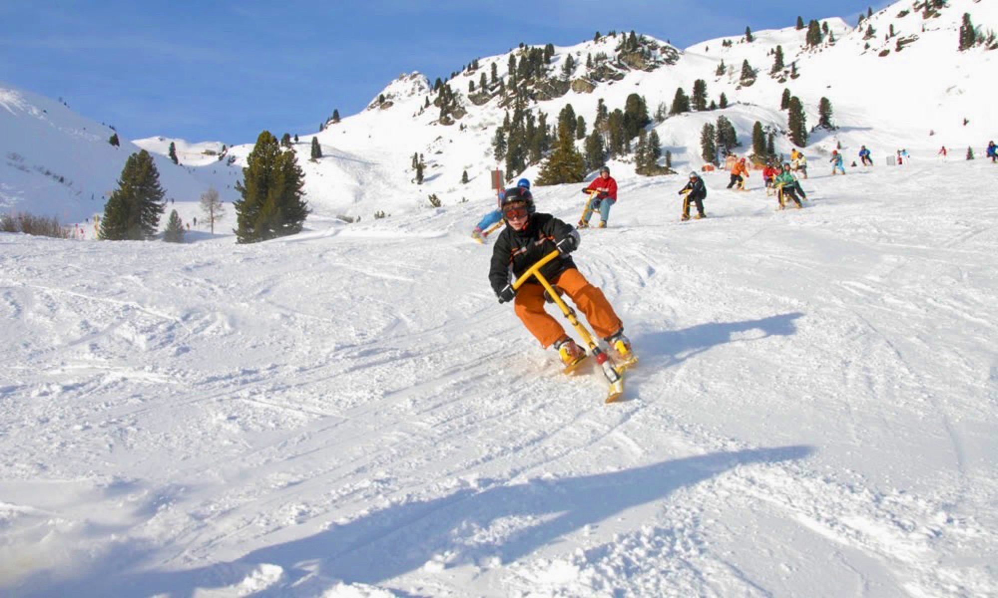 Snowbikers on snowy slopes.