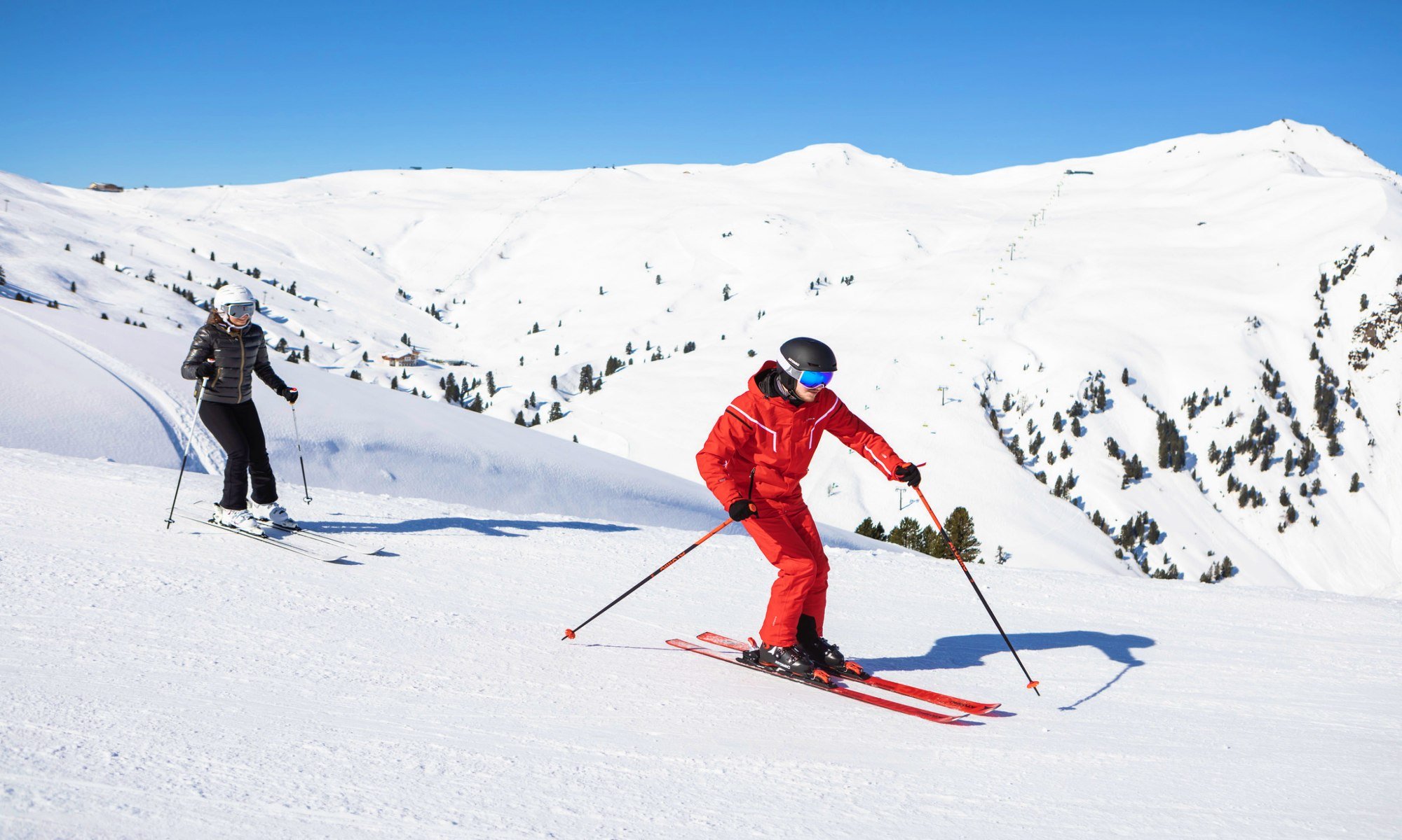 A ski instructor and his pupil on the slopes