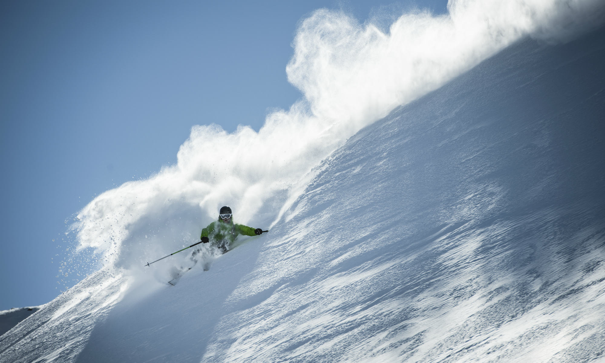 A deep snow skier gliding through the fresh powder snow.
