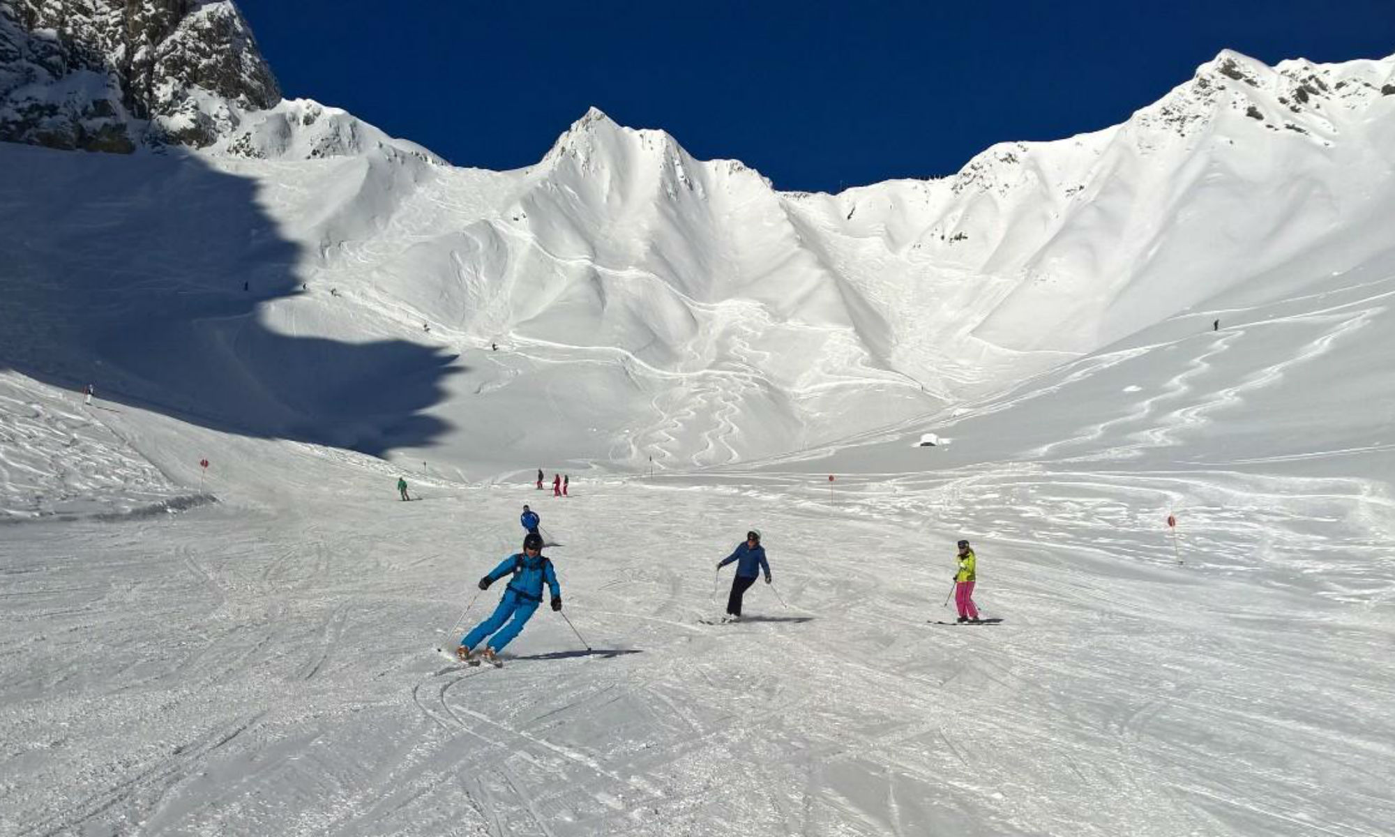 3 skiers on a beginner friendly slope in the ski resort of St Anton.