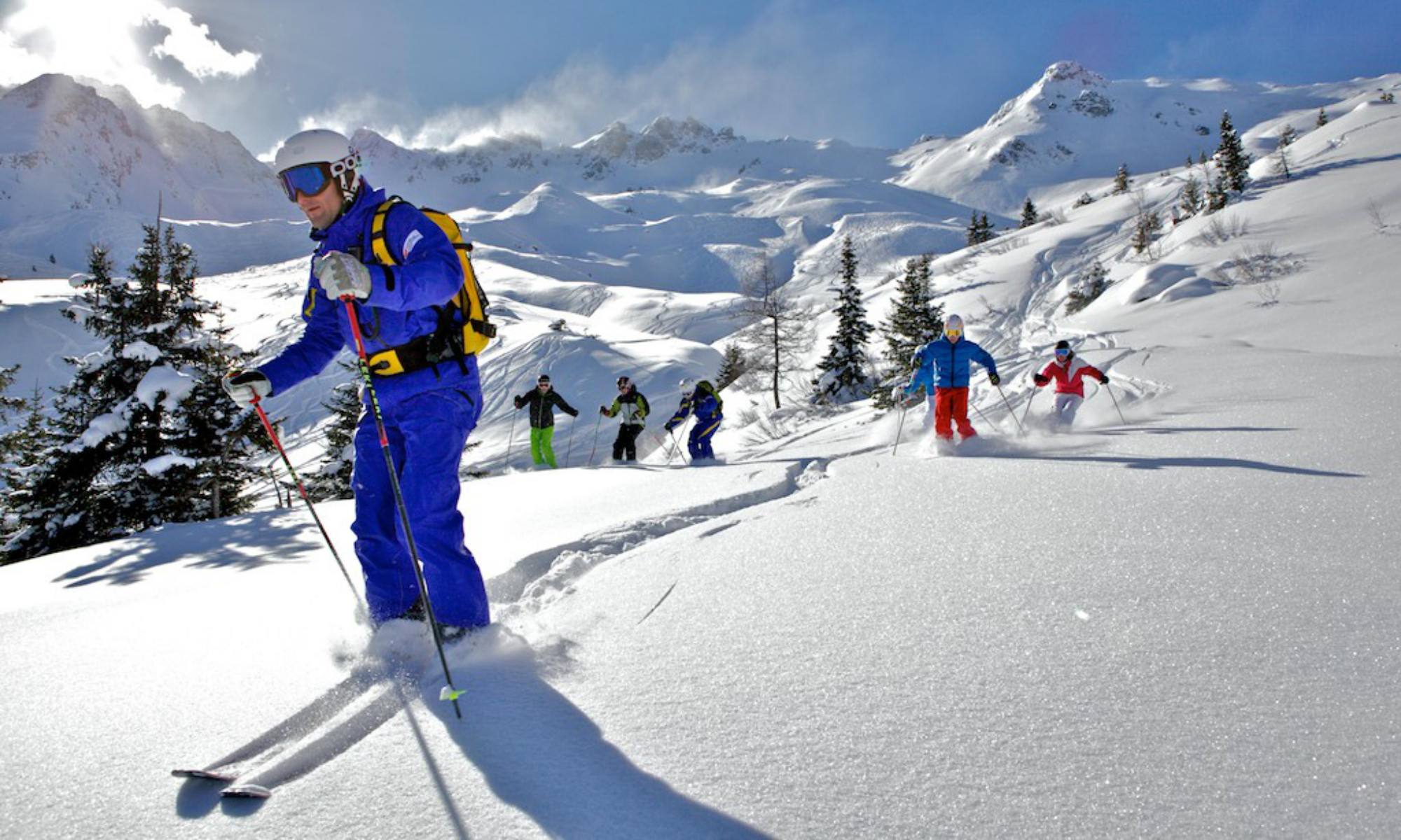 Ski instructors with a group of adults during a freeride lesson in the Gasteinertal valley.