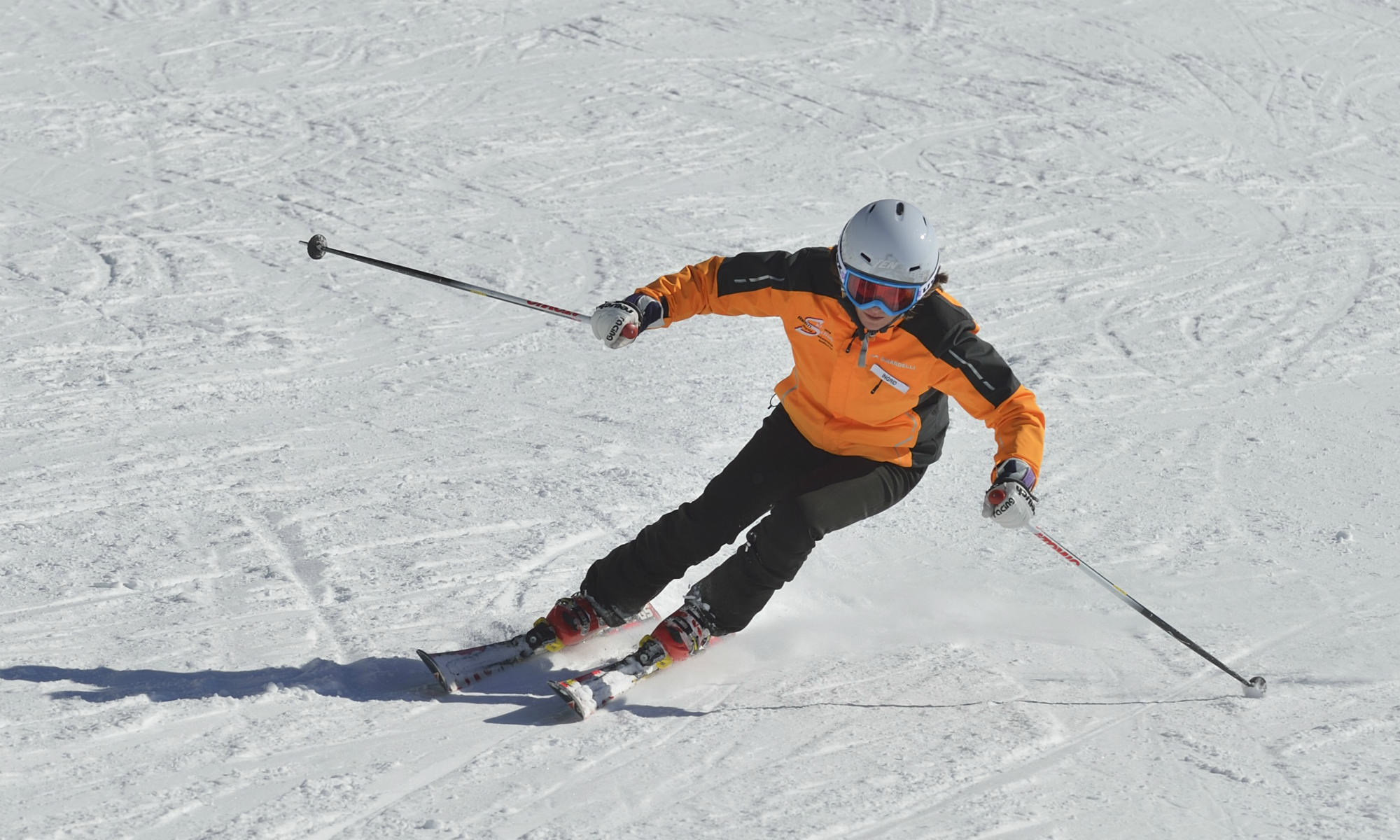 A skier demonstrates alpine skiing with the right body posture.