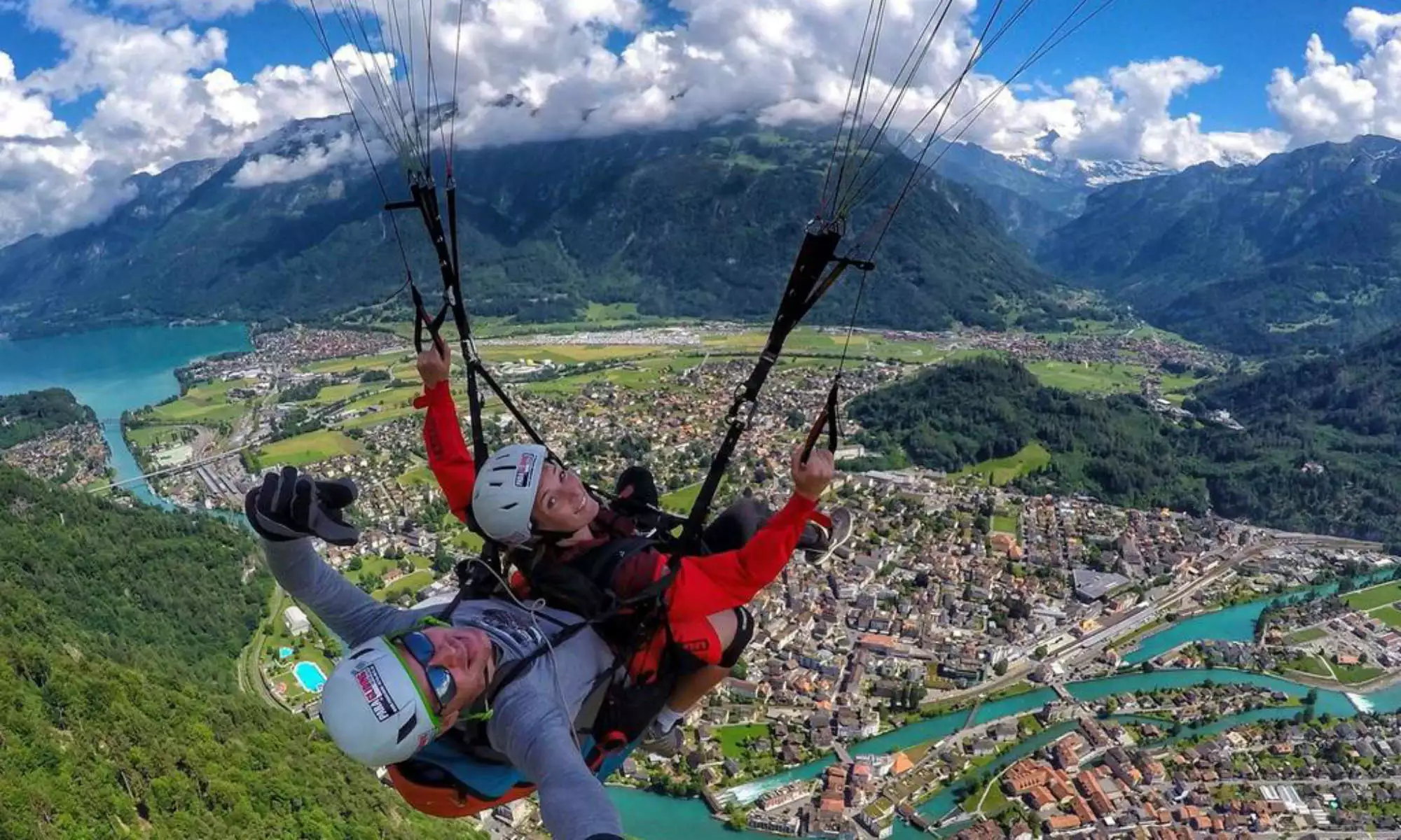 Un pilote tandem avec son passager au-dessus de la ville d'Interlaken.