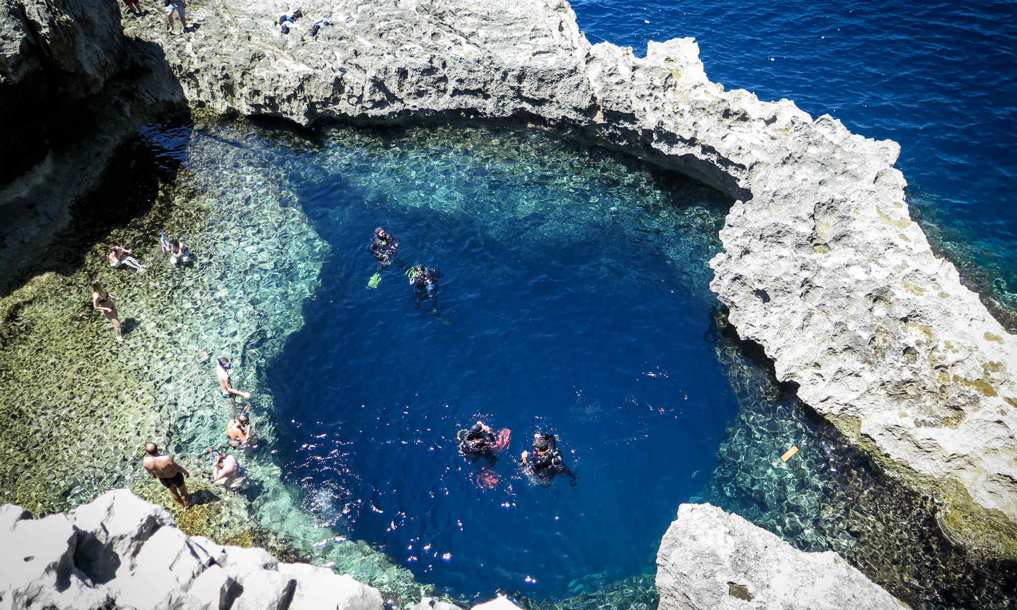 A couple of divers are preparing to dive down the blue hole, a dive site that shouldn’t be missed when scuba diving in Malta.