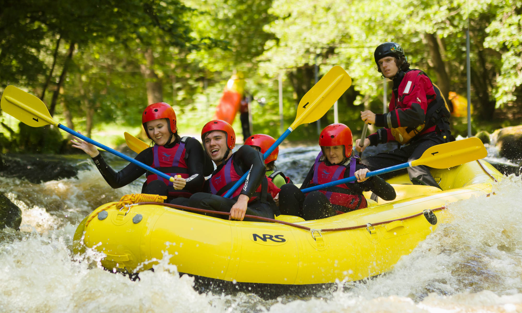 A group of people rafting on the River Tryweryn in North Wales.