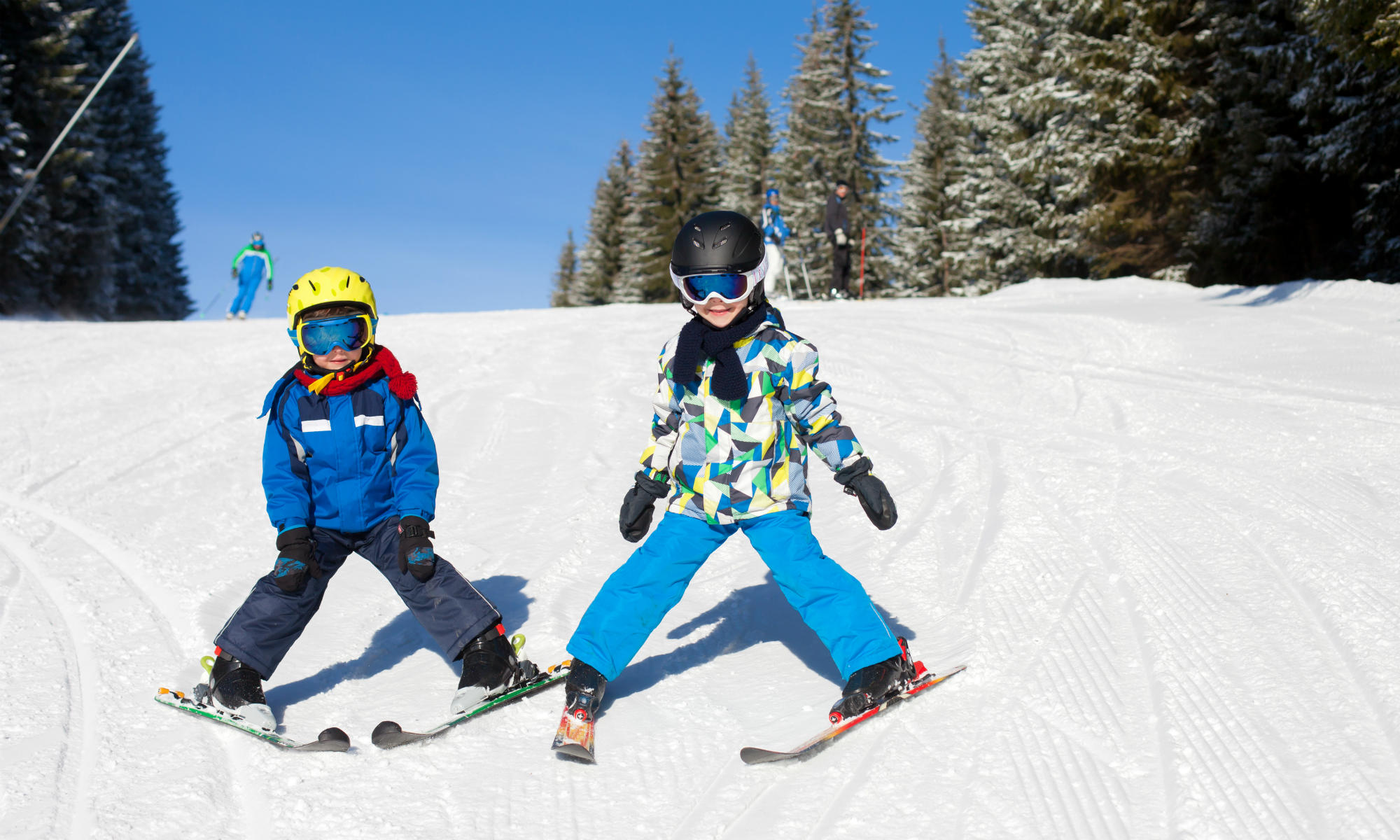 Young skiers practice the snow plough.