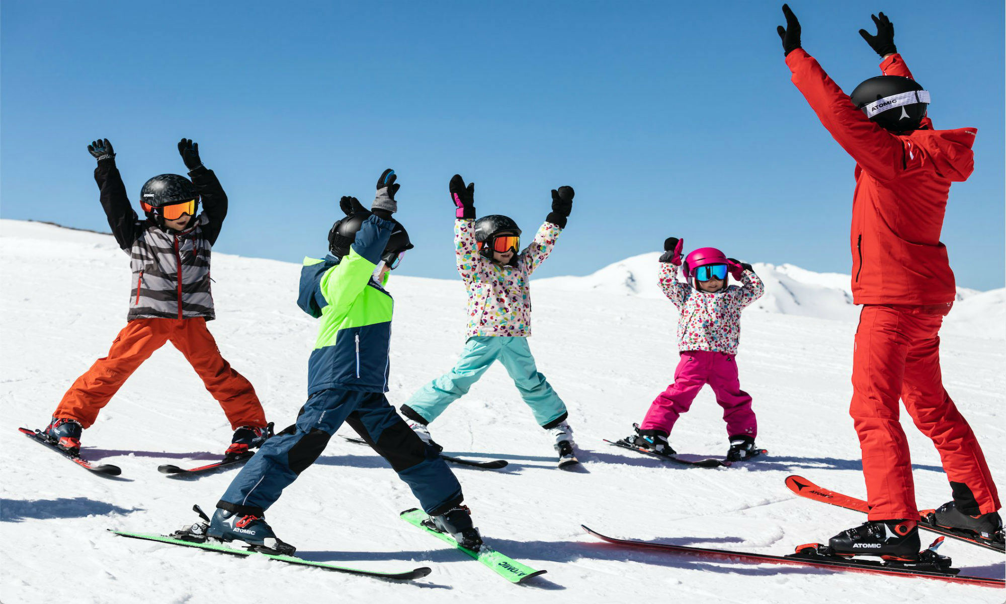 Kids doing exercises with their ski instructor during a group ski lesson in Tignes.