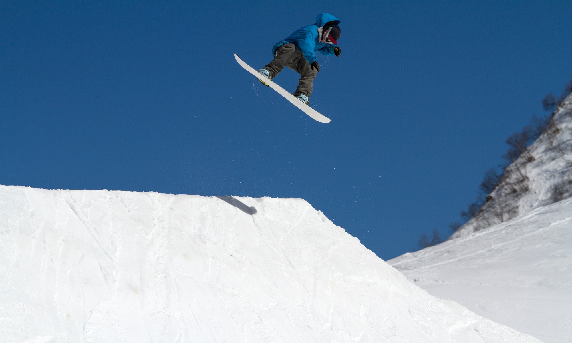 Snowboarder riding a kicker in Avoriaz. 