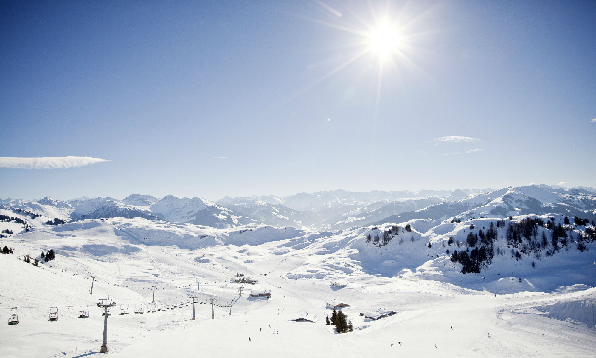 Sunny mountain view of Kitzbühel ski slopes.