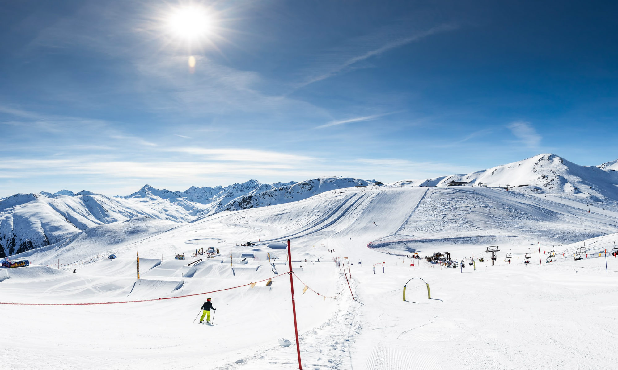 Sunny day view over the snow-sure slopes of Livigno.