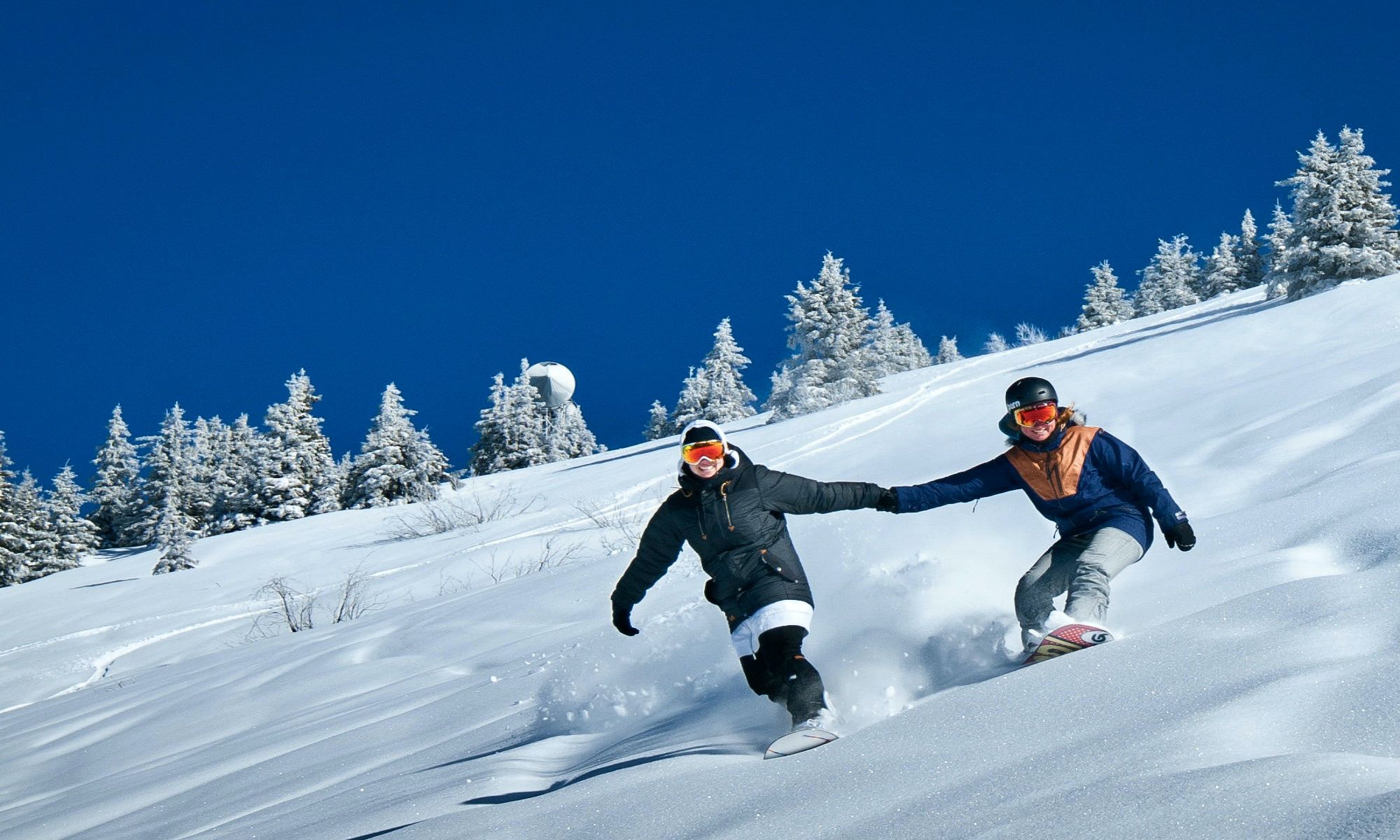 Two snowboarders freeriding on fresh snow at Avoriaz.