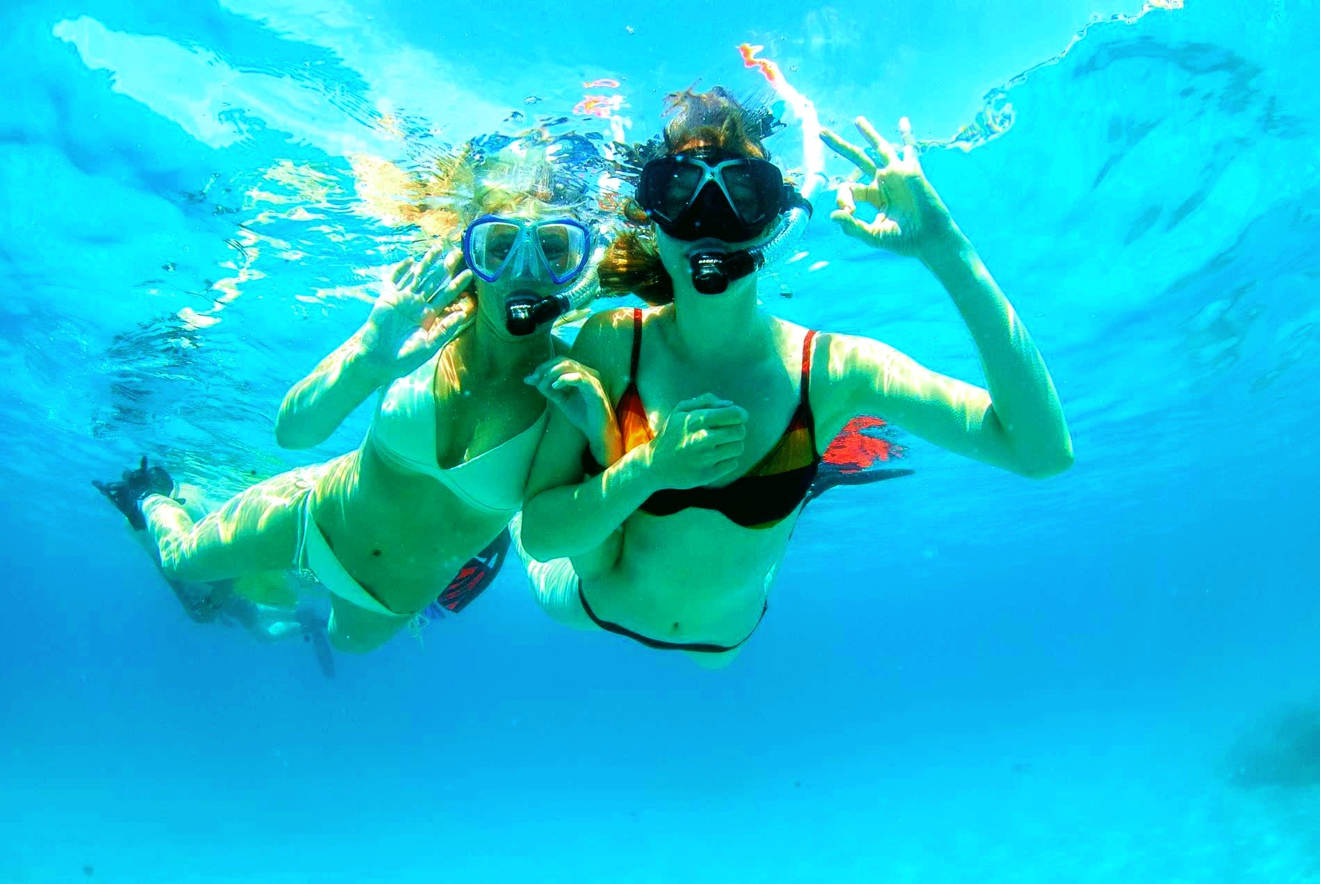 Two girls explore the underwater world of Mallorca on a snorkeling excursion.