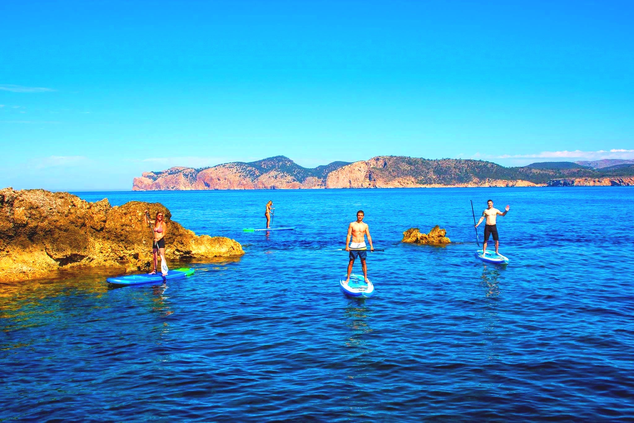 Some guys are taking part in a SUP tour in Mallorca.