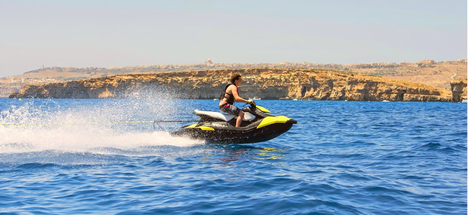 A jet ski speeds through the sea of Malta.