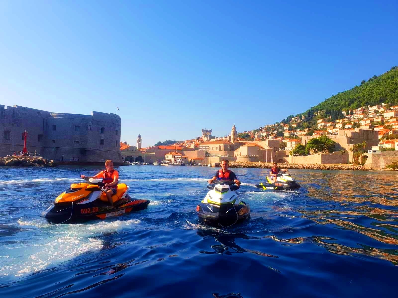 A group of participants of the Jet Ski excursion to Dubrovnik is leaving the city. 