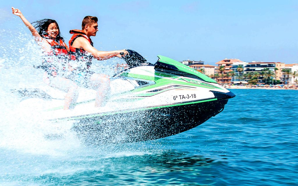 Two young people enjoy Jet Skiing in Barcelona, a beautiful outdoor activity in Barcelona.