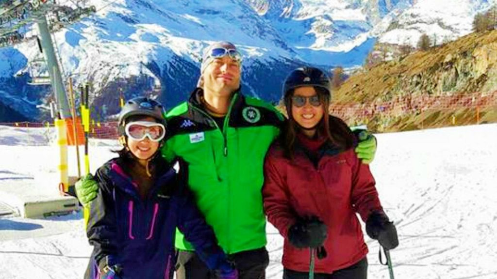 Two girls learn to ski in Zermatt with a ski instructor.