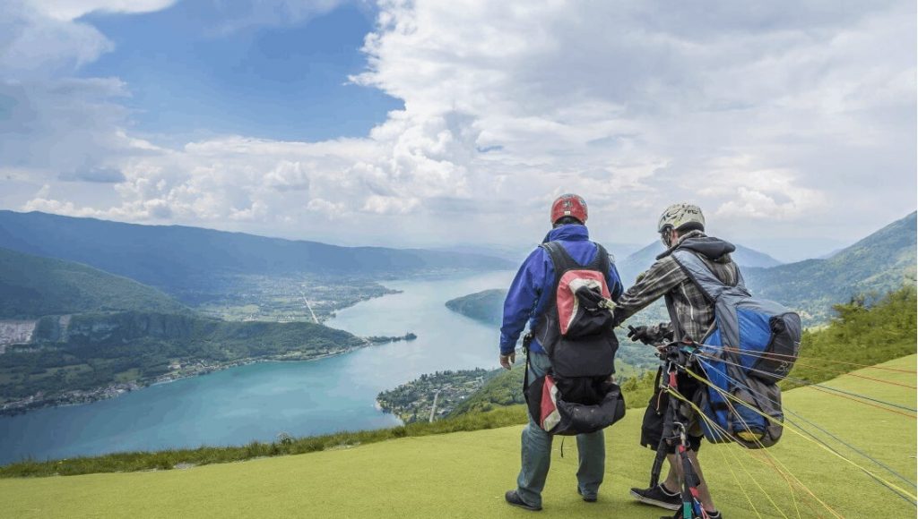 Paragliders prepare for their flight over Lake Annecy.