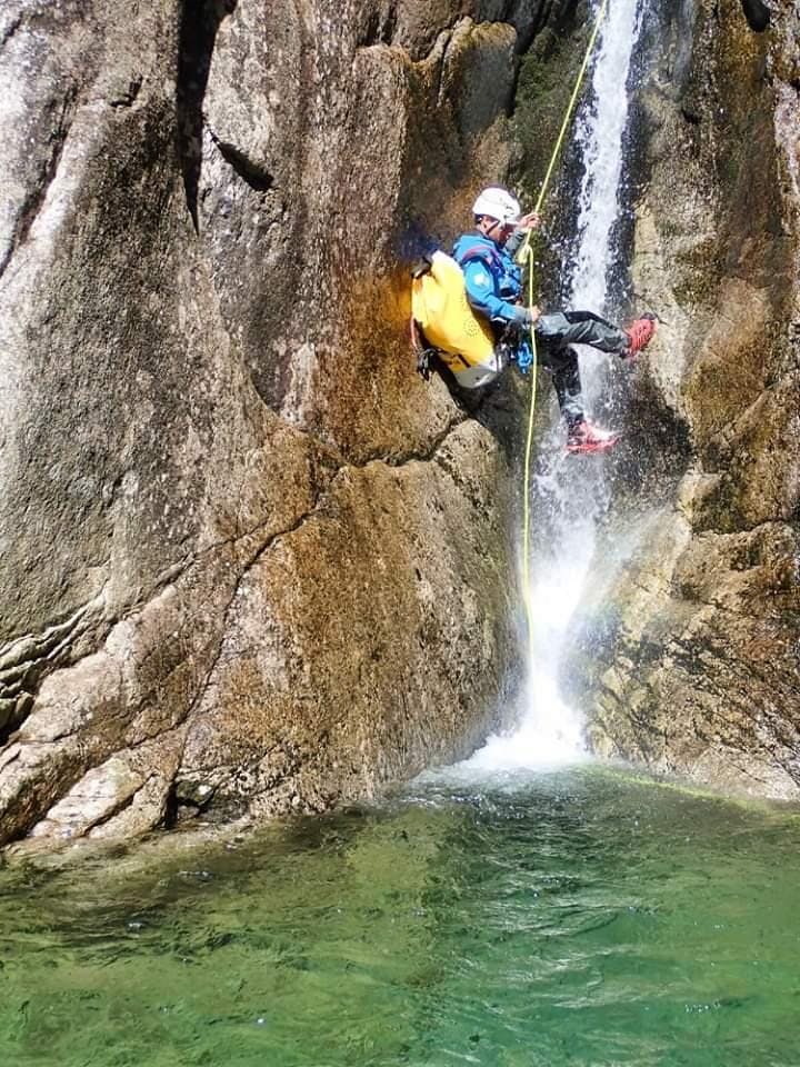 A participant in a canyoning tour in the Sorba river abseils. 