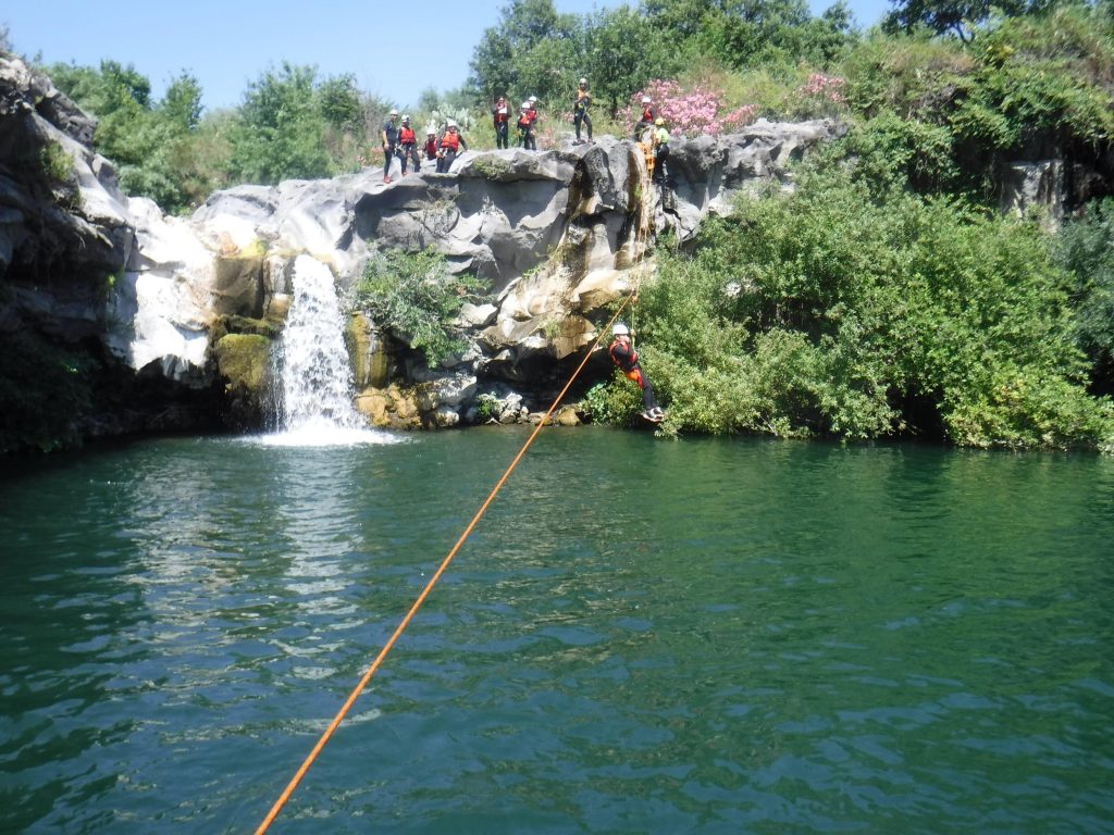 Participants in the canyoning tour in Sicily try out the zipline.