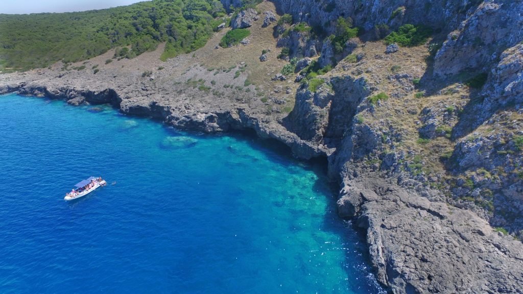 A view from above of a boat trip with snorkelling in Porto Selvaggio.