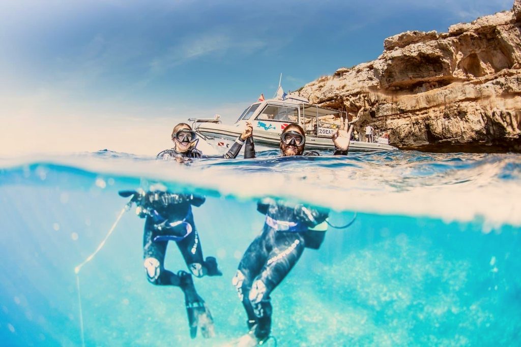 A couple celebrating their first time scuba diving in Spain.