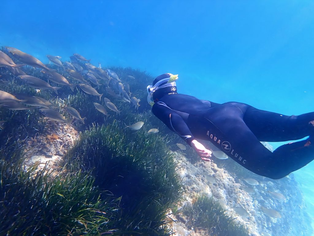 A boy has fun during a snorkeling trip in Cala Delta. 
