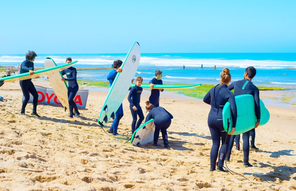 A group is getting ready to go surfing in Portugal.