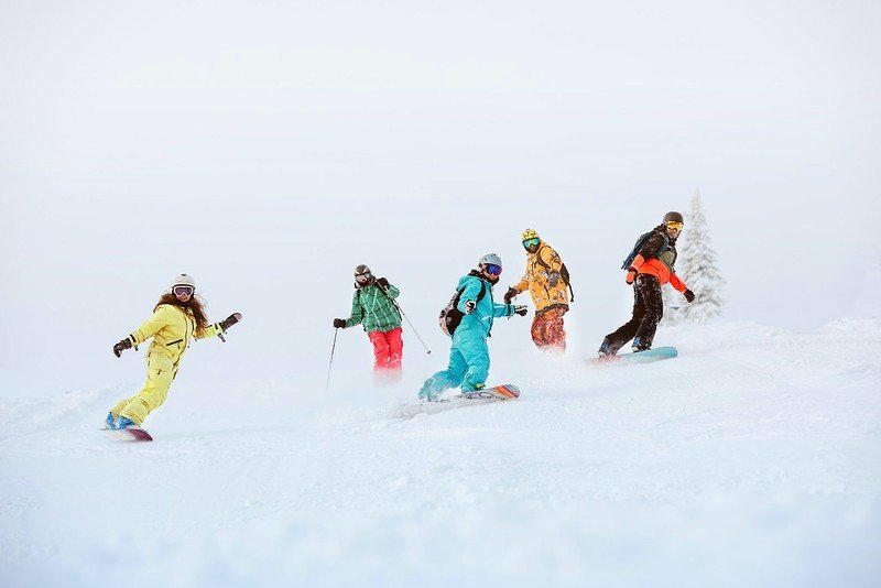 Some snowboarders participate in group lessons and learn how to snowboard.