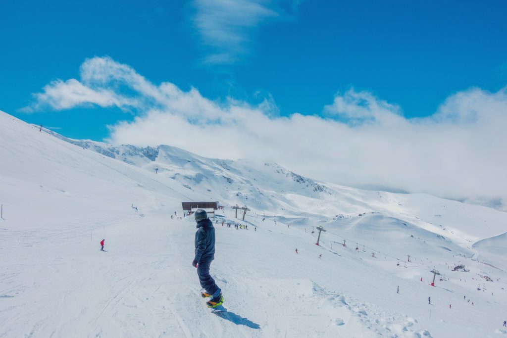 A snowboarder descends a slope in Pradollano ski resort in the Sierra Nevada mountains. 