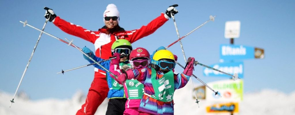 Kids are learning how to ski during kids ski lessons in their family ski holidays.