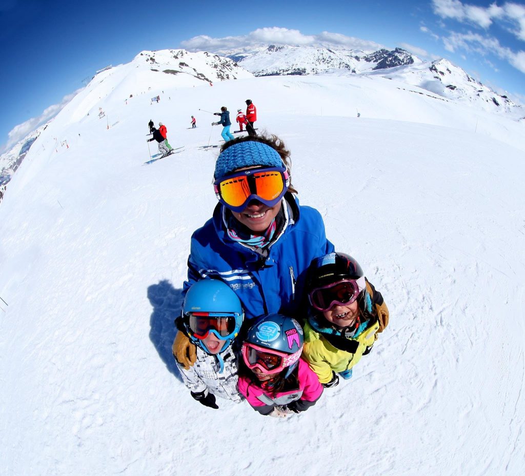 Kids are happy while learning how to ski in France during a nice family ski trip.
