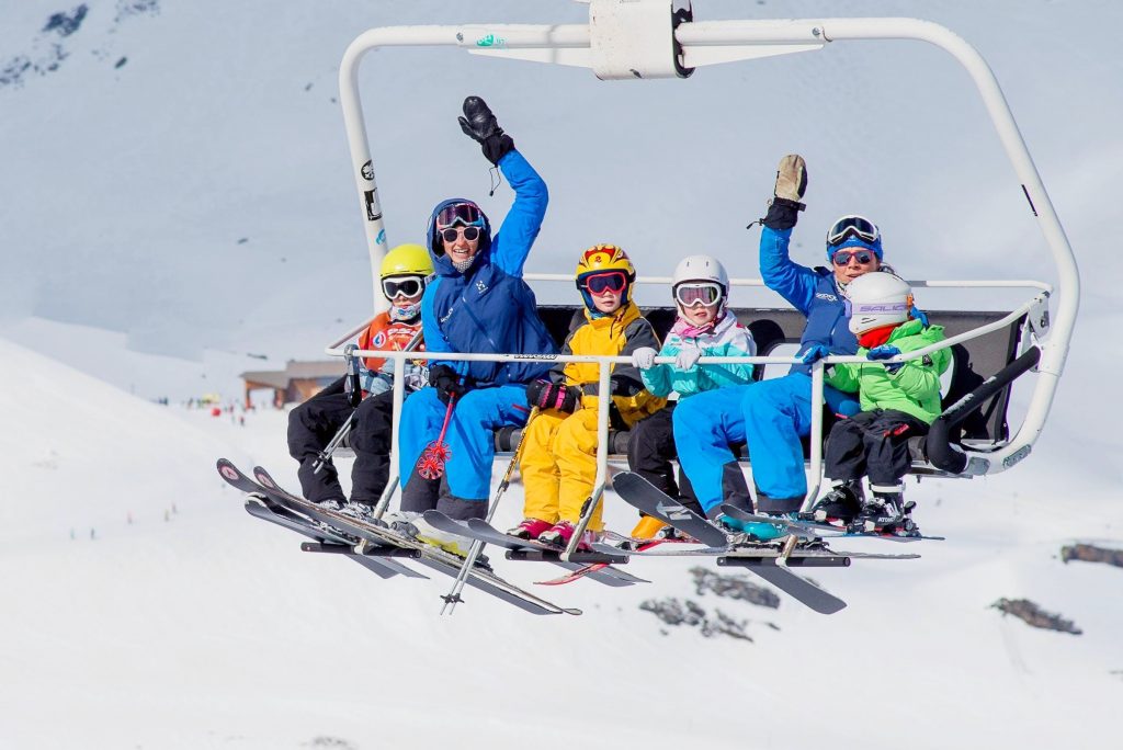 Kids are having fun on a lift during skiing in the 3 Valleys.