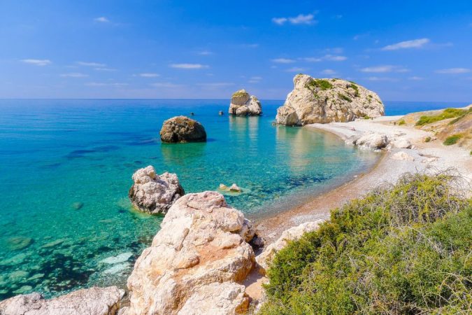 View of Aphrodite's Rock in Cyprus where people go swimming. 