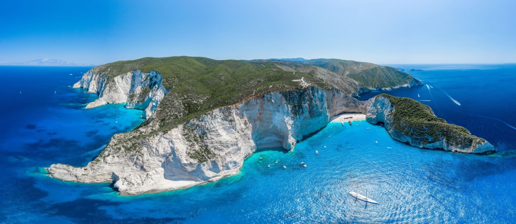 Stunning views of a beach in Zakynthos where boat & visitors stop by.