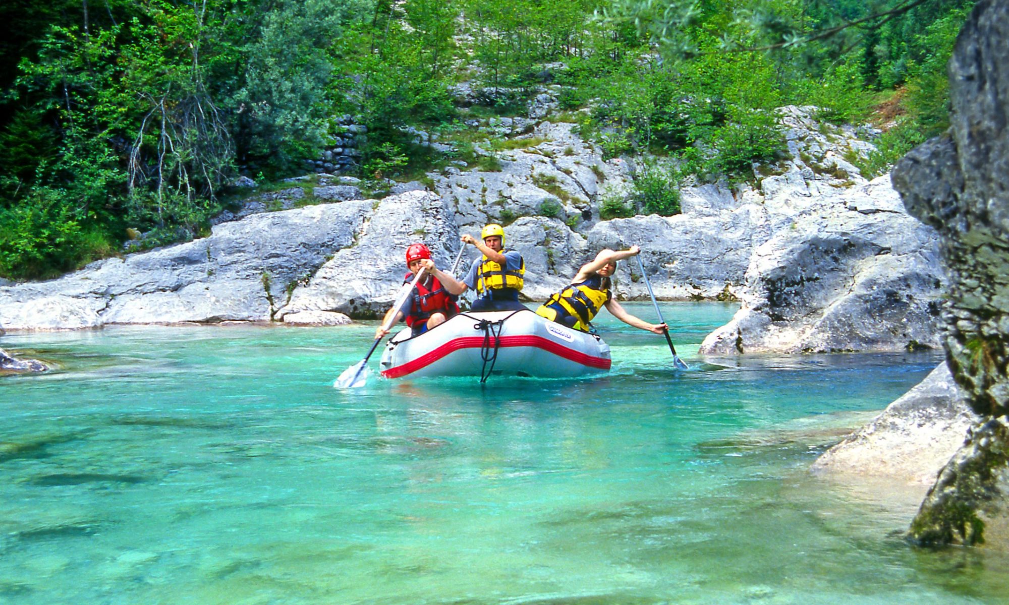 A group of friends enjoying a rafting activity in a river.