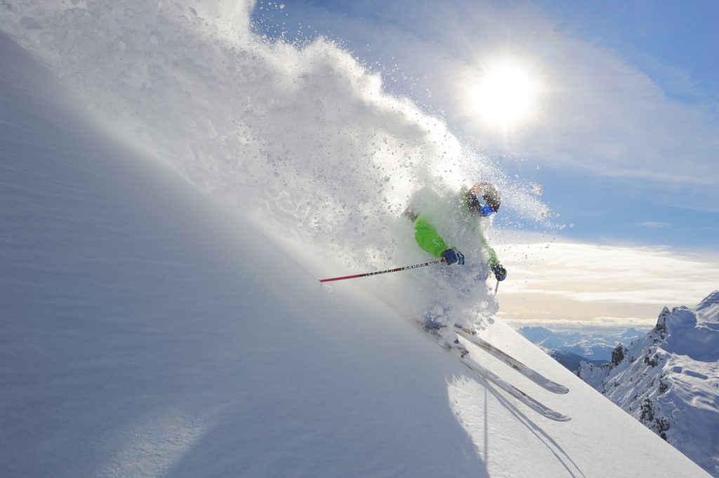 Ein Skifahrer fährt im Tiefschnee abseits der Piste.