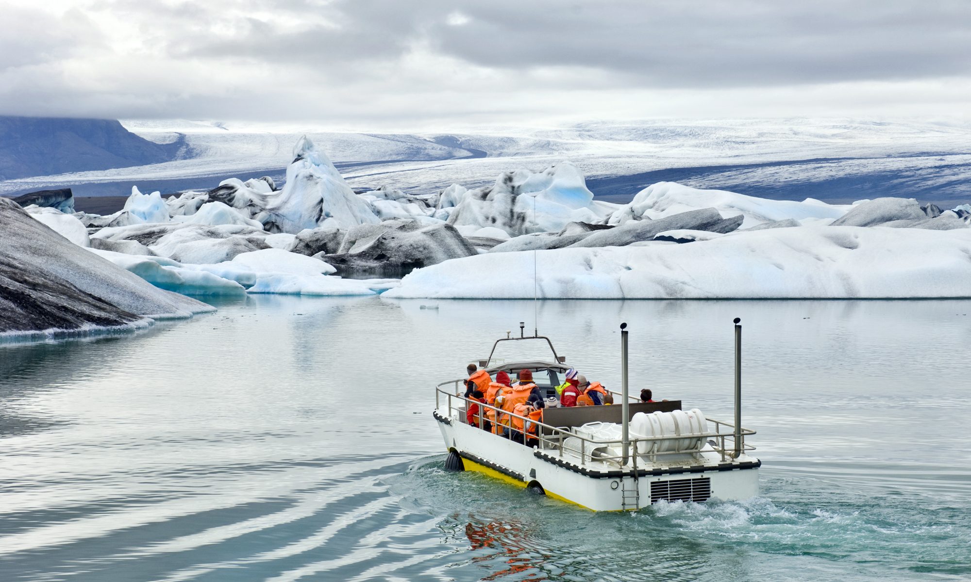 An amphibious vehicle taking tourists for a cruise around the icebergs in the Jokulsarlon glacier lake, where huge chunks of ice from the Vatnajokull glacier float out to the Atlantic ocean.