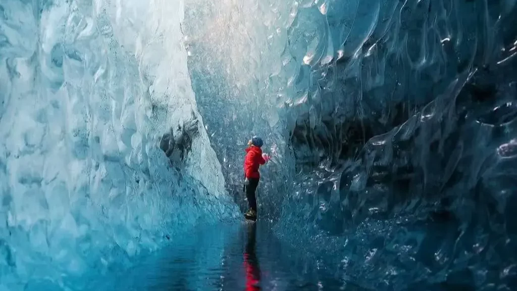 A person looking at the top of the Sapphire Ice Cave
