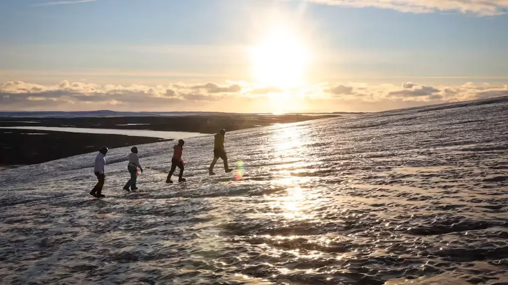 4 people on a glacier.