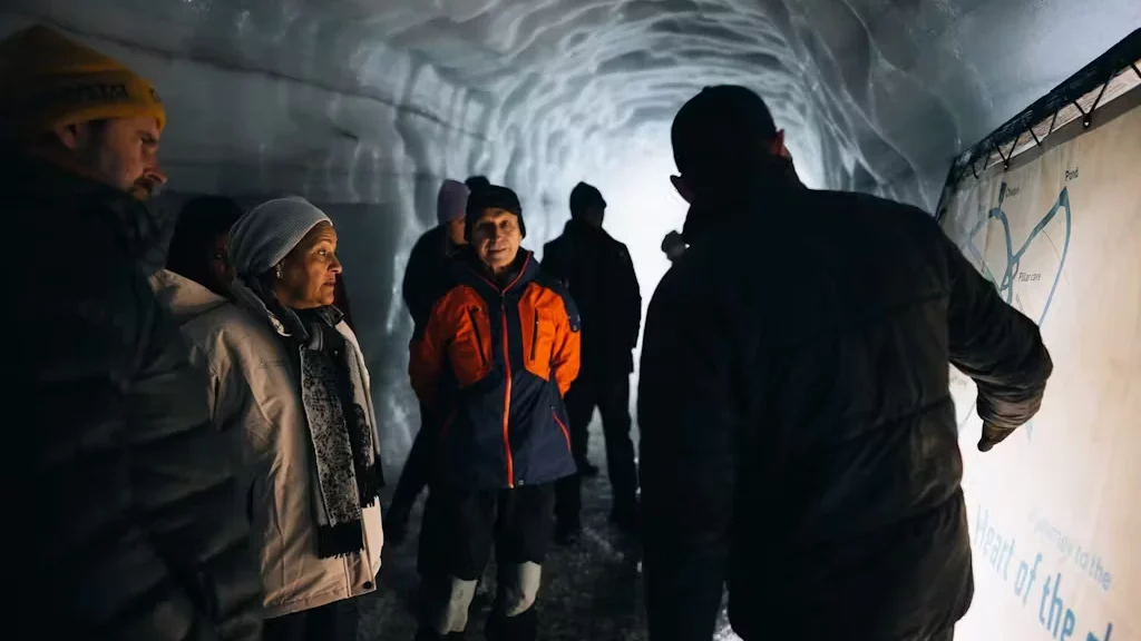 A guide explains the Langjökull ice tunnel to his group.