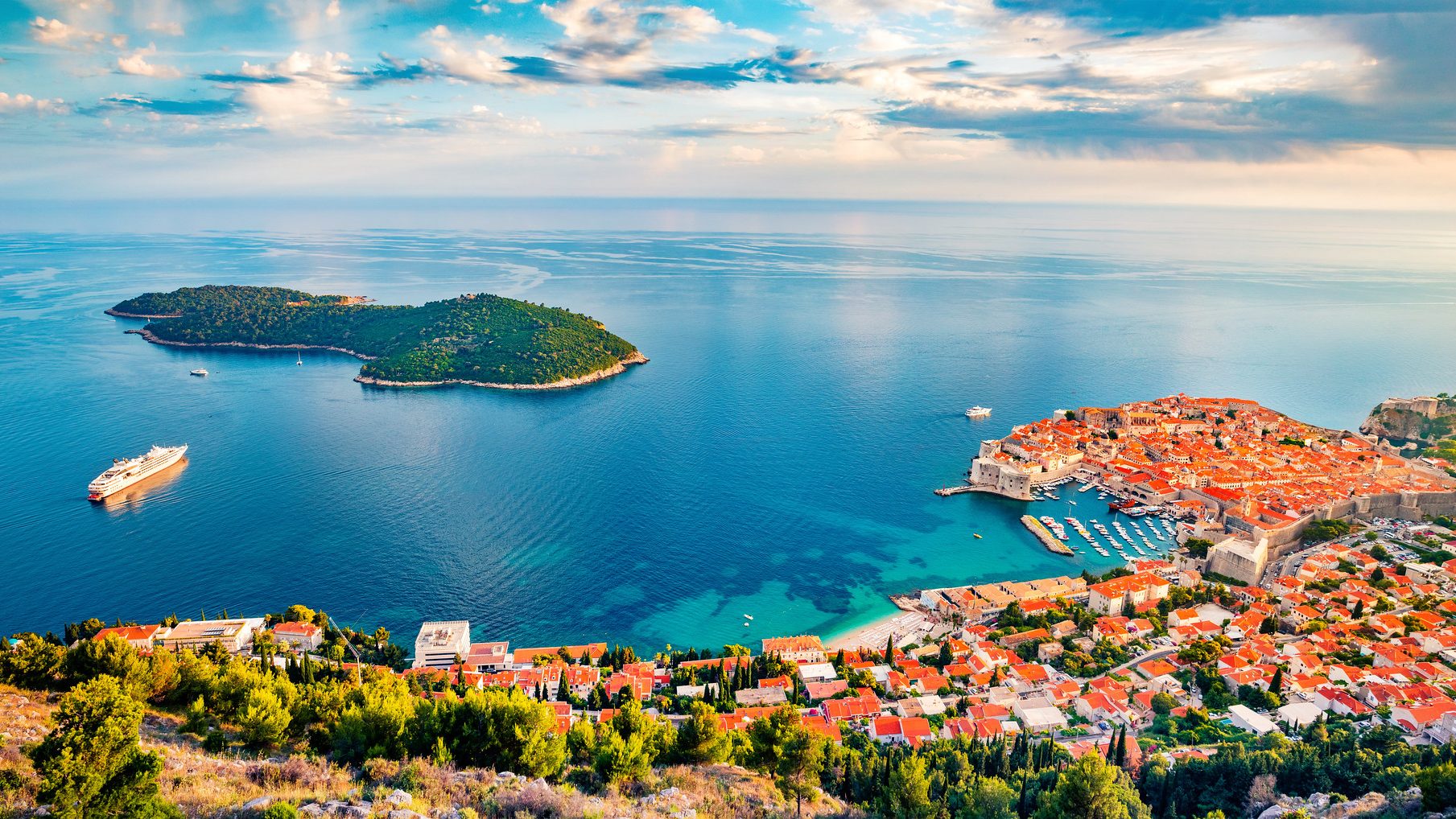 Scenic view of Dubrovnik, showcasing its historic architecture and coastal beauty under a clear blue sky.