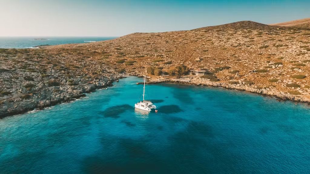 The catamaran of DanEri Yachts with Dia Island as the background.